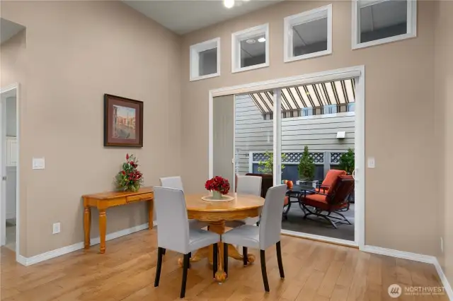 Spacious dining area with the sliding glass door leading to the super private outdoor space.