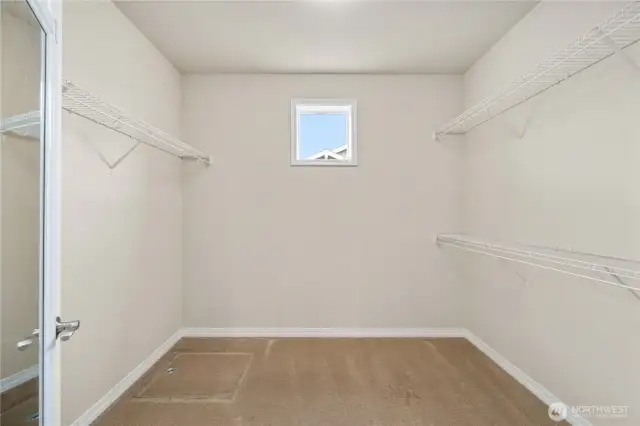 Large walk-in closet with a window for natural light.