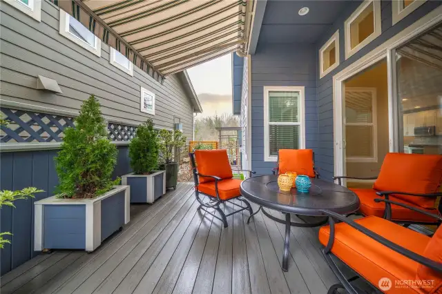 Super private outdoor space with composite decking, a motorized awning and custom planter boxes.