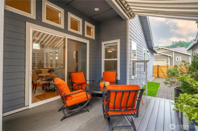 Oversized sliding glass doors open up to a beautiful composite deck and a motorized awning. This side of the home gets delightful SW exposure.
