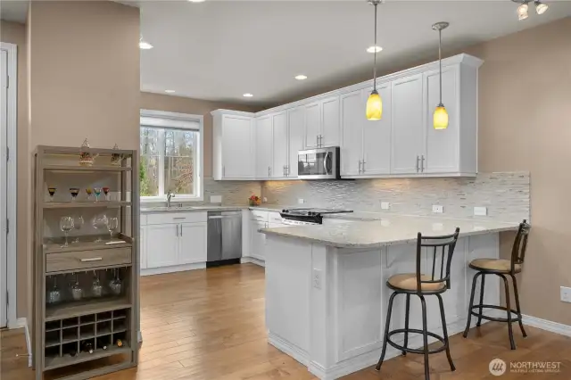 Gorgeous and pristine kitchen with Quartz countertops, full heigh backsplash, beautiful wood work and 42" cabinetry w/ crown and of course amazing vistas out of the window!