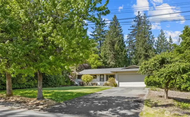 Idyllic tree-lined yard, long driveway, and 2-car garage.