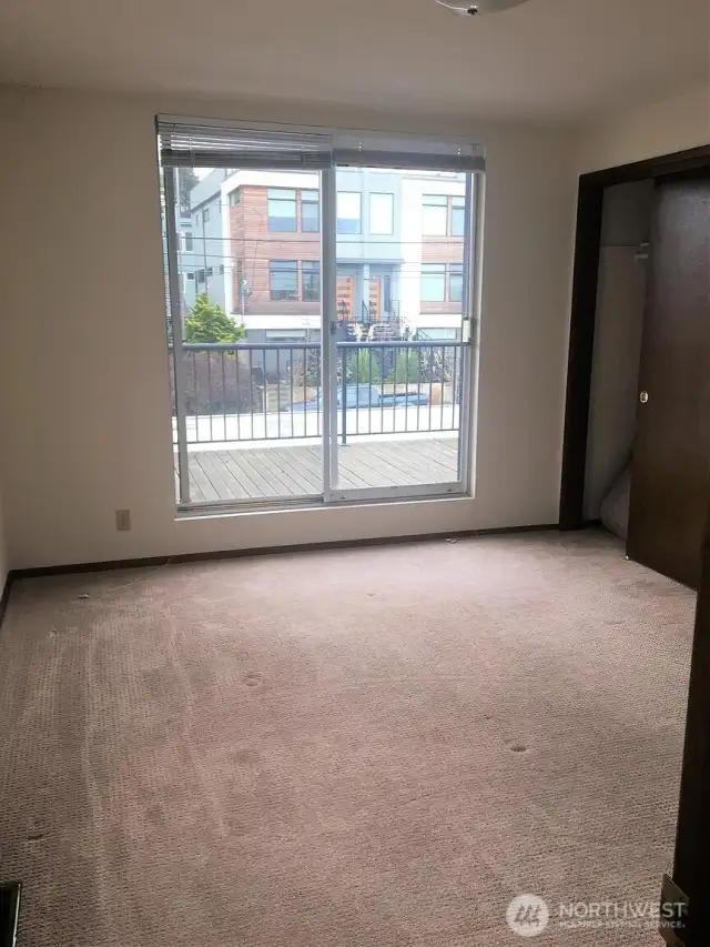 Unit 3 Primary bedroom with deck facing Alki Ave SW