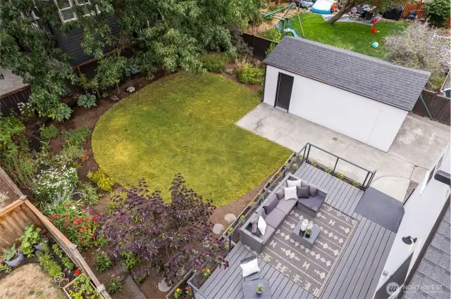 Lush backyard gets lots of natural light and is a gardener's paradise!