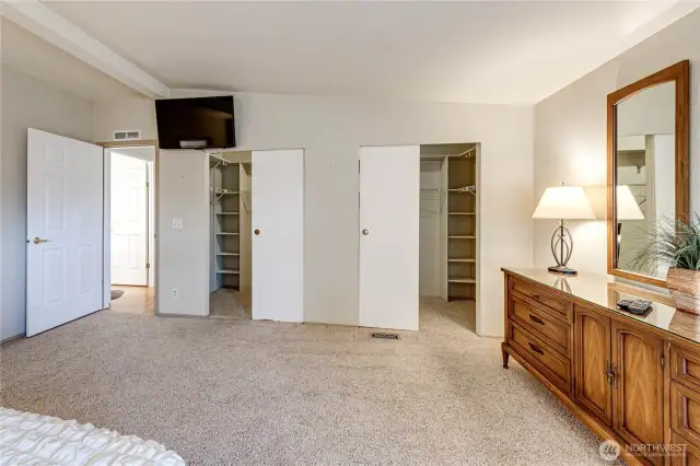 Dual walk-in closets with abundant shelving.