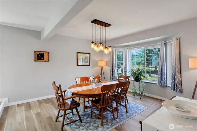 Spacious living room or dining room off front of the home with custom lighting and new trim.