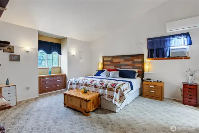 Primary bedroom with vaulted ceiling