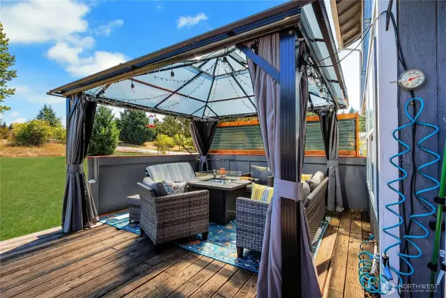 Back deck offers great relaxation with gazebo and privacy screen.  This area can be enjoyed anytime of the year.