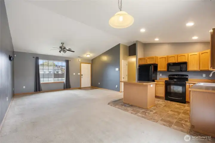 Bright & Ooen living area with a large picture window and seamless flow to the dining and kitchen.