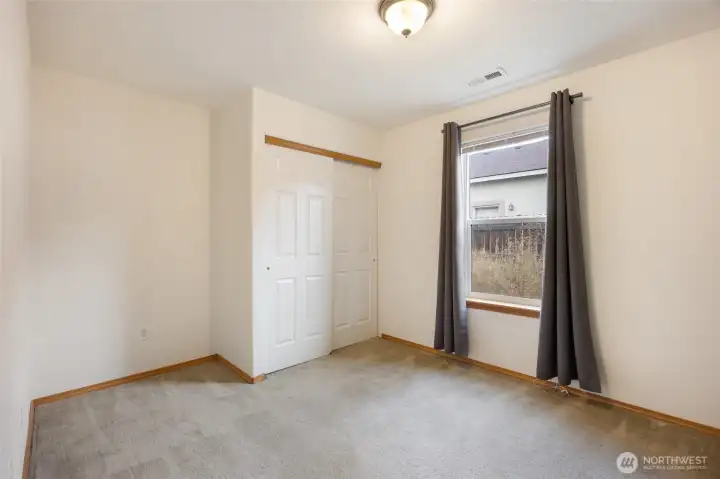 Bedroom #2 has views of side back yard and spacious closet.