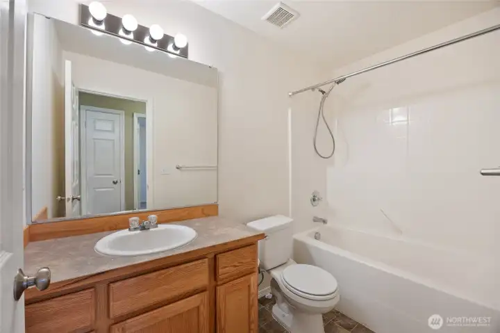Main bath offers bright, welcoming lighting & thoughtful design, with a storage closet just across the. way-perfect for linens and everyday essentials.