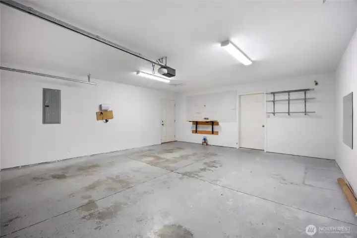 Insulated 2-car garage with shelves, peg board, and collapsible workbench-Clean and ready to use.