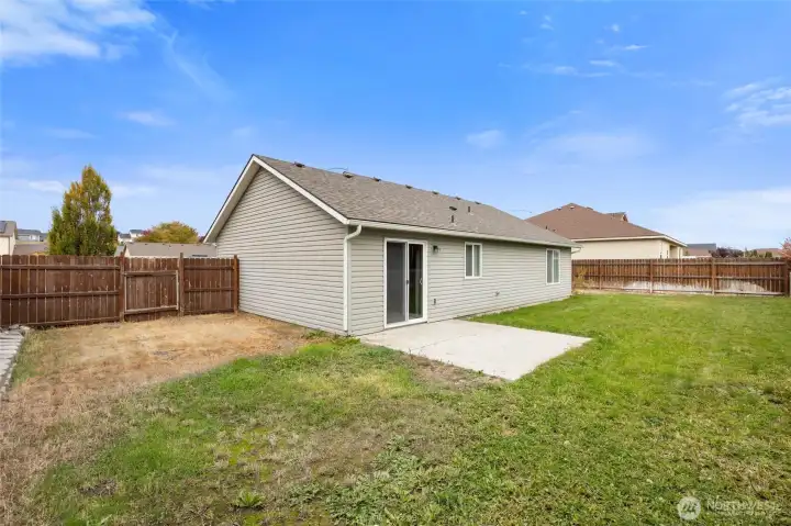 Large fully fenced backyard with patio slab and dual gates - private and ready for outdoor fun!
