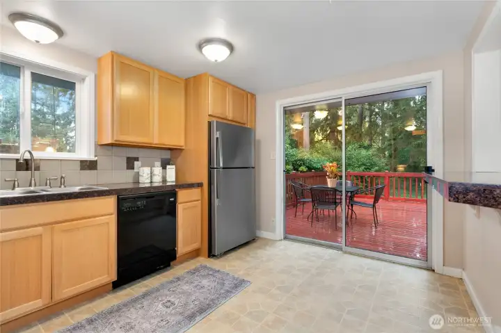 Kitchen overlooking backyard and large deck.