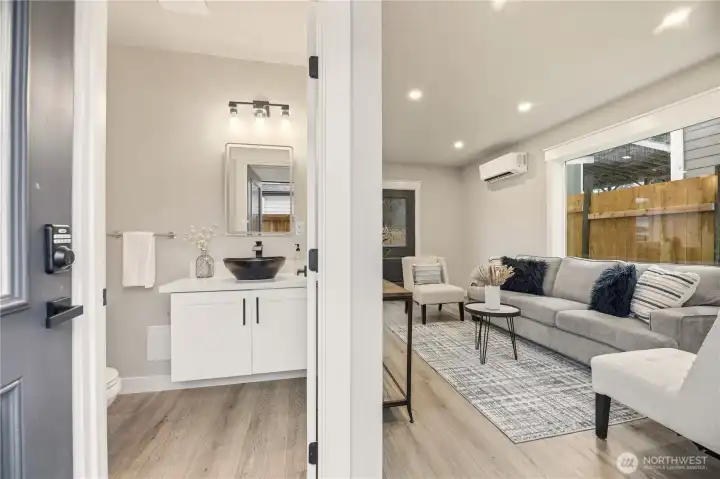 This home has two entrances. This one faces the south. As you enter you see the great room on the right and the half bath right in front of you.