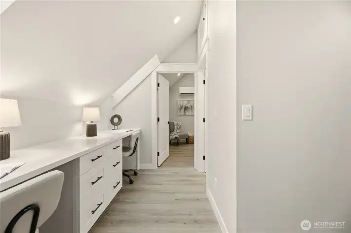 In between the bedrooms is a dedicated works space for two, along with built in drawers. This would make a great work from home space, homework area, or even crafting area. Two skylights provide more light.