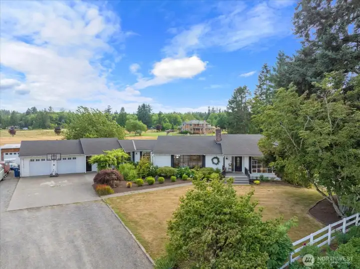 Spacious rambler with daylight basement, mature ladscaping and usable acreage!