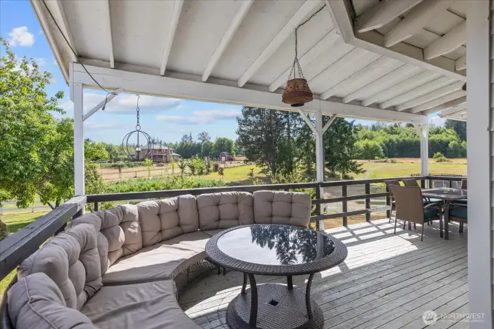 Expansive covered deck off dining room overlooking mature landscaping and flower garden.