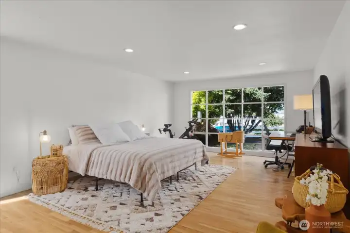 Primary suite with amazing, oversized window overlooking the front yard with mature landscaping.
