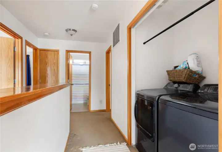 In the hall at the top of stairs, laundry area is conveniently located.