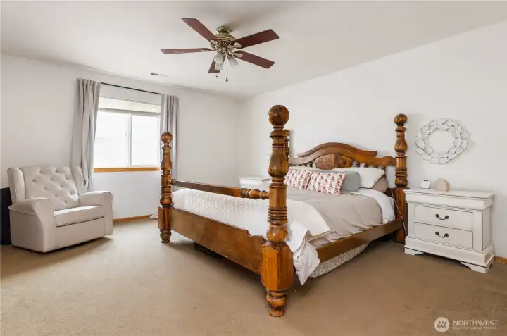 The primary bedroom is incredibly generous with more than enough room for a king size bed.