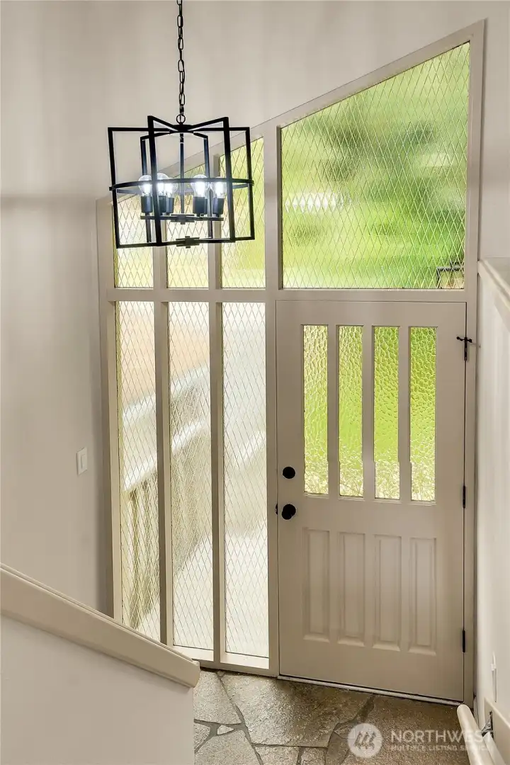 Open foyer with vaulted ceilings