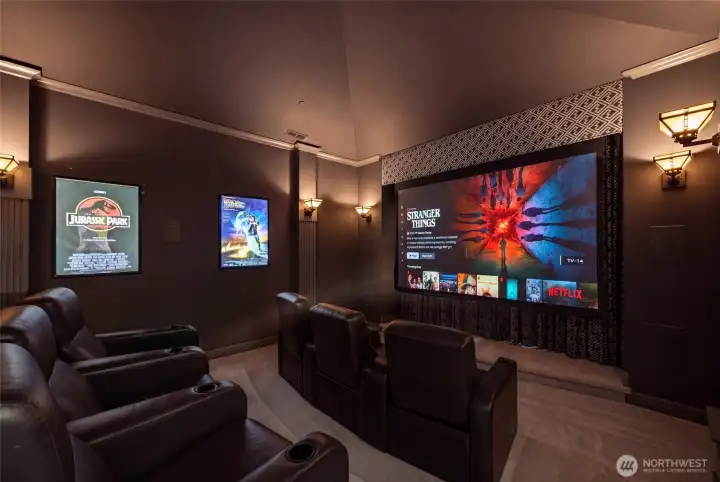 Amazing cinematic Home theater. Features a power screen, high-end surround sound, power lounge seating and bar-top seating. Beyone the screen are large bay windows overlooking the private grounds. Mini-stage for performances!