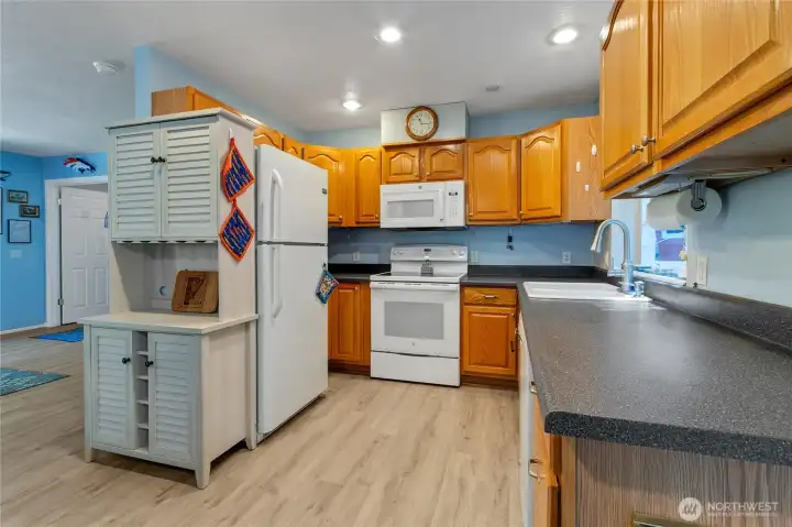 The kitchen boasts lots of cabinets and counterspace. Canned lighting is a nice addition