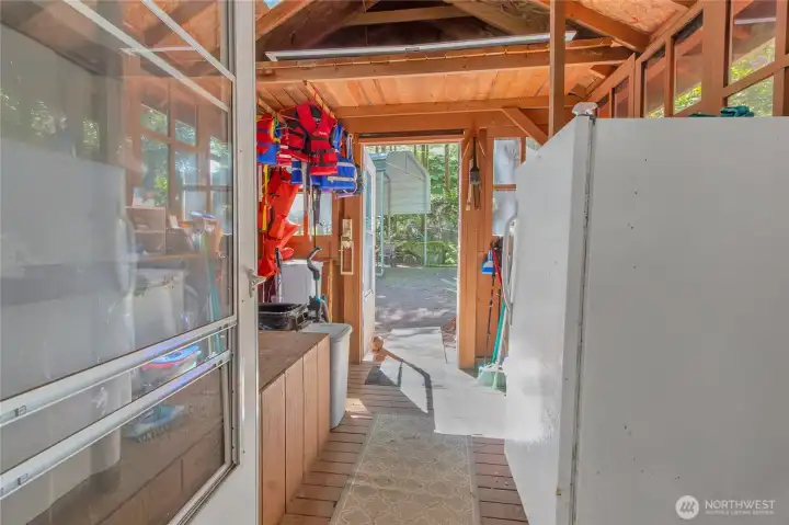coming from the outside covered RV area into the house there is a storage area with extra fridge, etc
