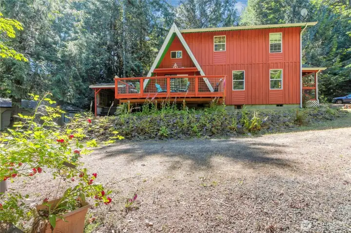 View of home as you walk around it. So much mature landscaping and a babbling creek to boot!