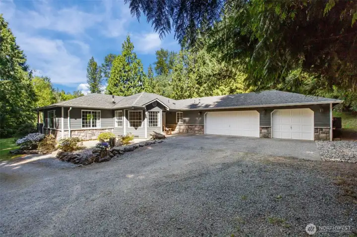 Inviting water feature and 3 car garage.