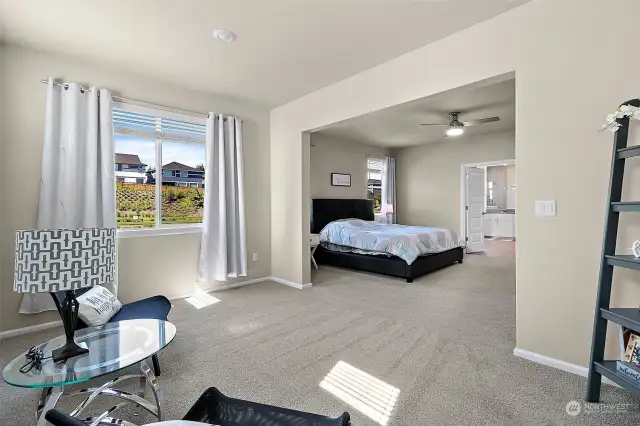 Step into a simply gorgeous primary bedroom that features a cozy seating area and an abundance of space.