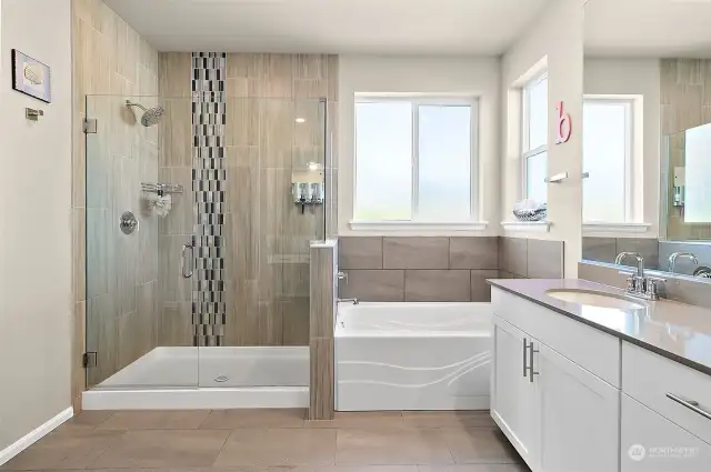 This luxurious space also includes a separate soaking tub and dual sinks, creating a serene and functional retreat where you can unwind and refresh in style.