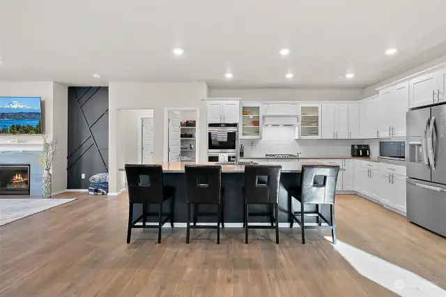 Welcome to your dream kitchen, where abundant cabinetry provides ample storage, ensuring everything has its place. The double oven makes cooking for any occasion a breeze, while the sleek subway tile backsplash adds a touch of modern elegance.