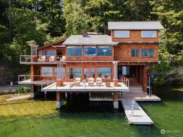 This home is notable as it is a rare home that is built into the rock and propels out over the lake.