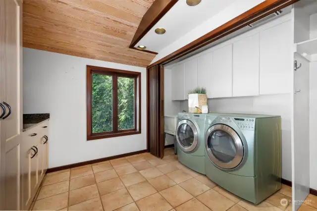 The laundry room is on the main level and has a tile floor. It is just adjacent to the back door and has built-in storage and a large closet.