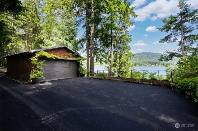 There is a detached 2 vehicle garage along the driveway with additional parking (more than twice of what you see in this photo) and new asphalt.