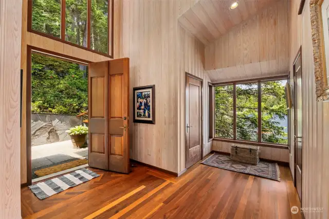 The front entry is breathtaking as the doors and floors are all Honduran mahogany, and the ceilings are soaring with large windows taking in the views and bringing in the sunlight.