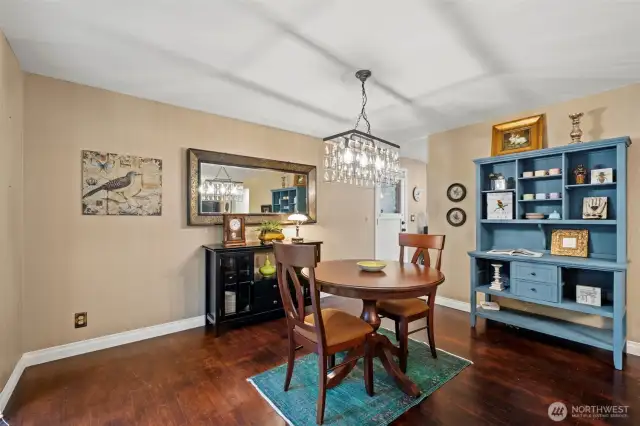 Another view of the dining room and the beautiful chandelier and hardwood flooring it embraces.