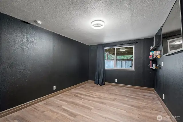 A second downstairs bedroom also has refreshed flooring. (This room is in the process of being painted to a lighter color.)