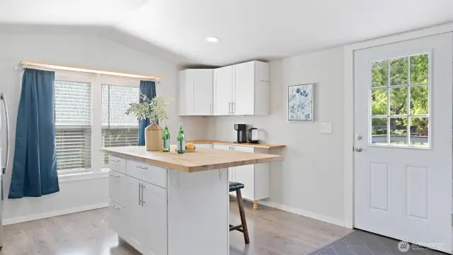 Warm butcher block counters and light-filled rooms give this home an inviting & welcoming feel from the moment you walk in.