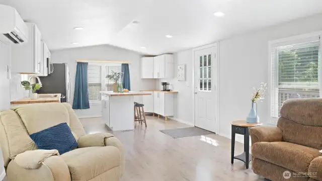 With tall ceilings, sleek recessed lighting, and beautiful laminate floors, this space feels open, modern, and totally welcoming.