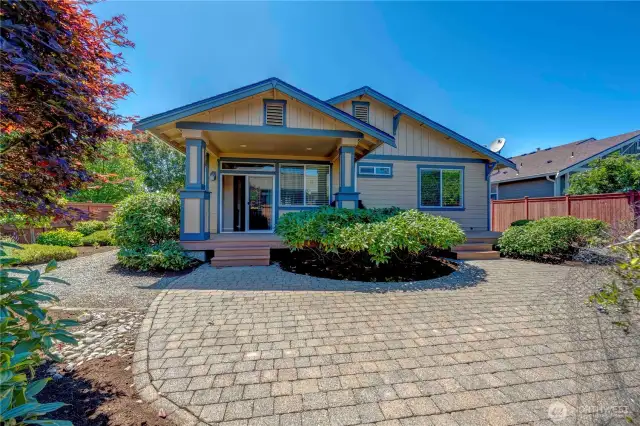 Professionally landscaped view of covered deck that stretches the entire width of the house.