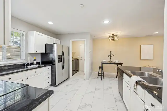 Newer Luxury vinyl flooring throughout kitchen and laundry room