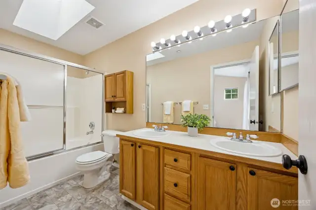 Primary Bathroom - Double sink, with tub/shower combo. New Skylight installed with Roof (July 2025)