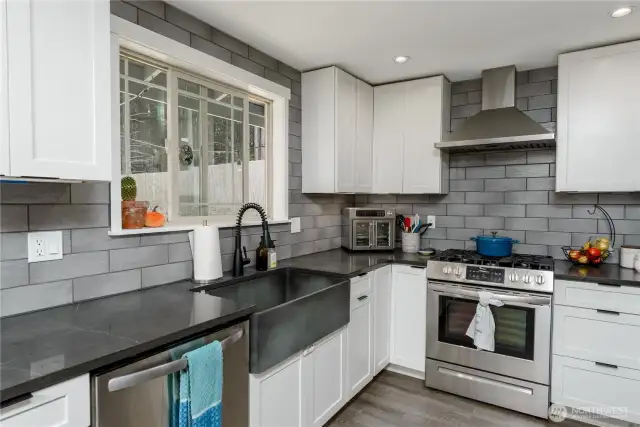 stylish backsplash, modern range hood... a kitchen you will love!
