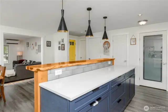 Functional kitchen island with pendant lighting - pantry off to the right
