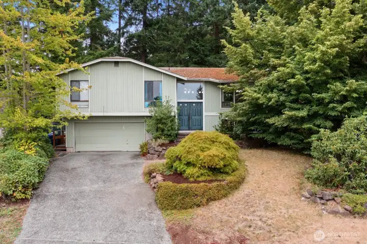 This home is ready for a fresh vision! Tucked away on a quiet street, surrounded by nature.