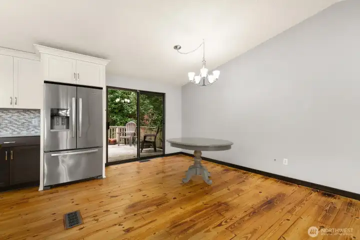 Dining area sits off slider to private deck and backyard.