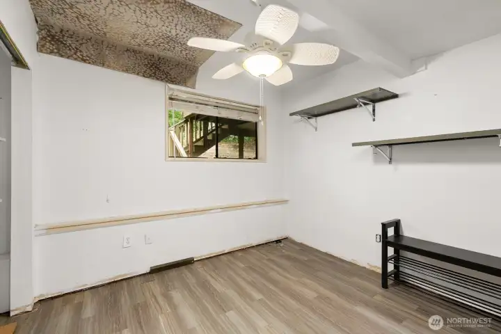 Lower level bedroom. Fabric on ceiling is covering a drywall hole from a previous plumbing repair.